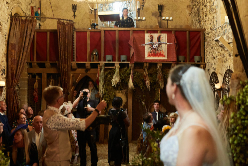 Bride in her veil inside the candlelit church as guests gather