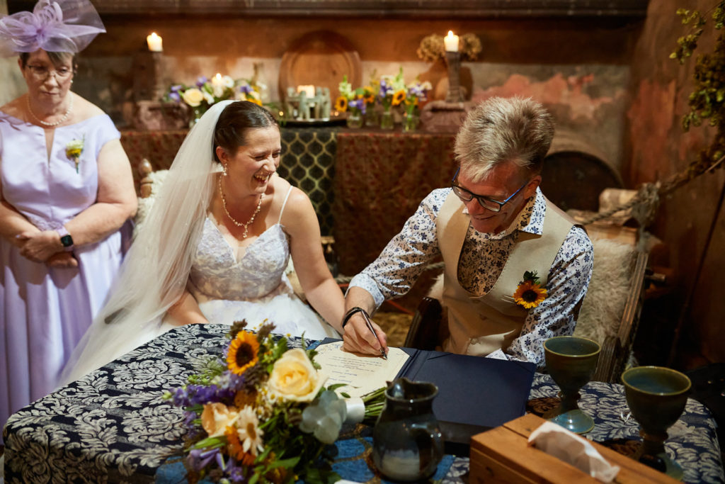 Bride and groom signing the register