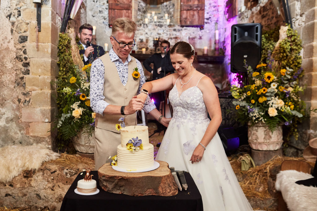 Bride and groom cutting their wedding cake