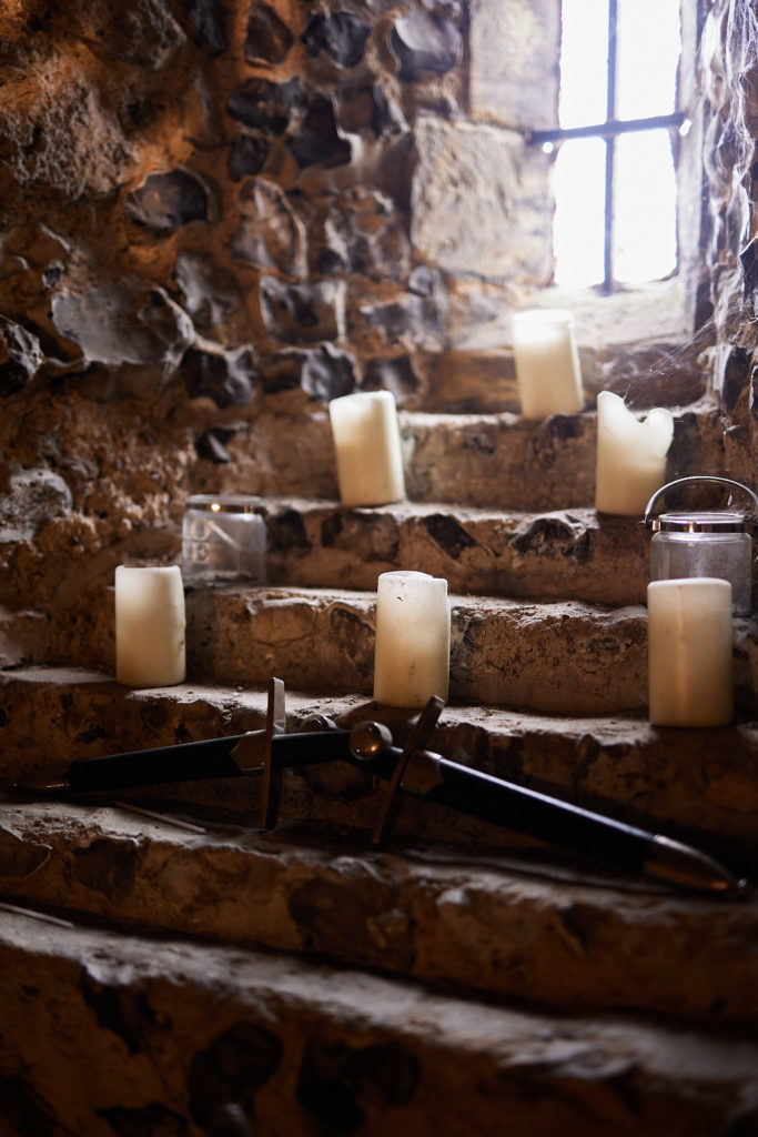 Candles and a sword on the stone steps inside the church