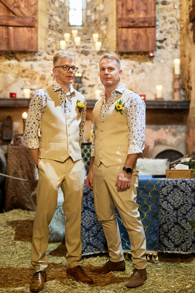 Groom and best man in matching floral shirts and beige waistcoats