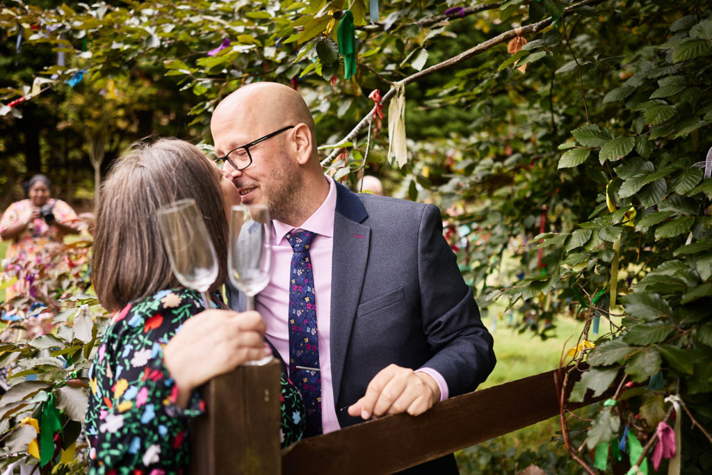 Two wedding guests hugging