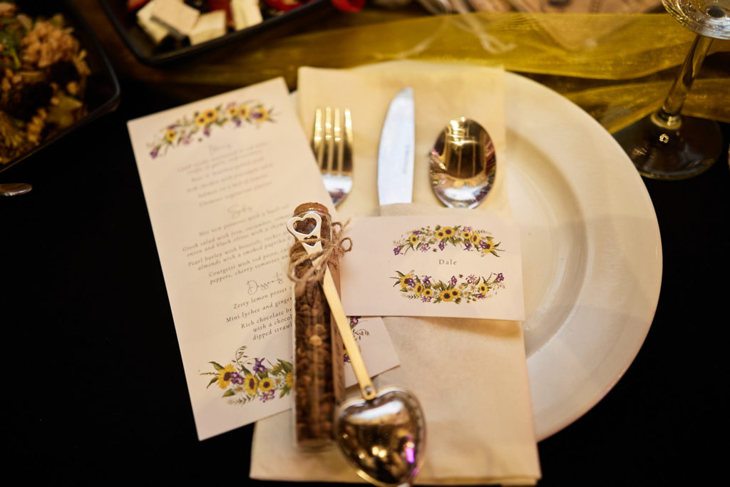 Place setting with a menu card and vintage cutlery