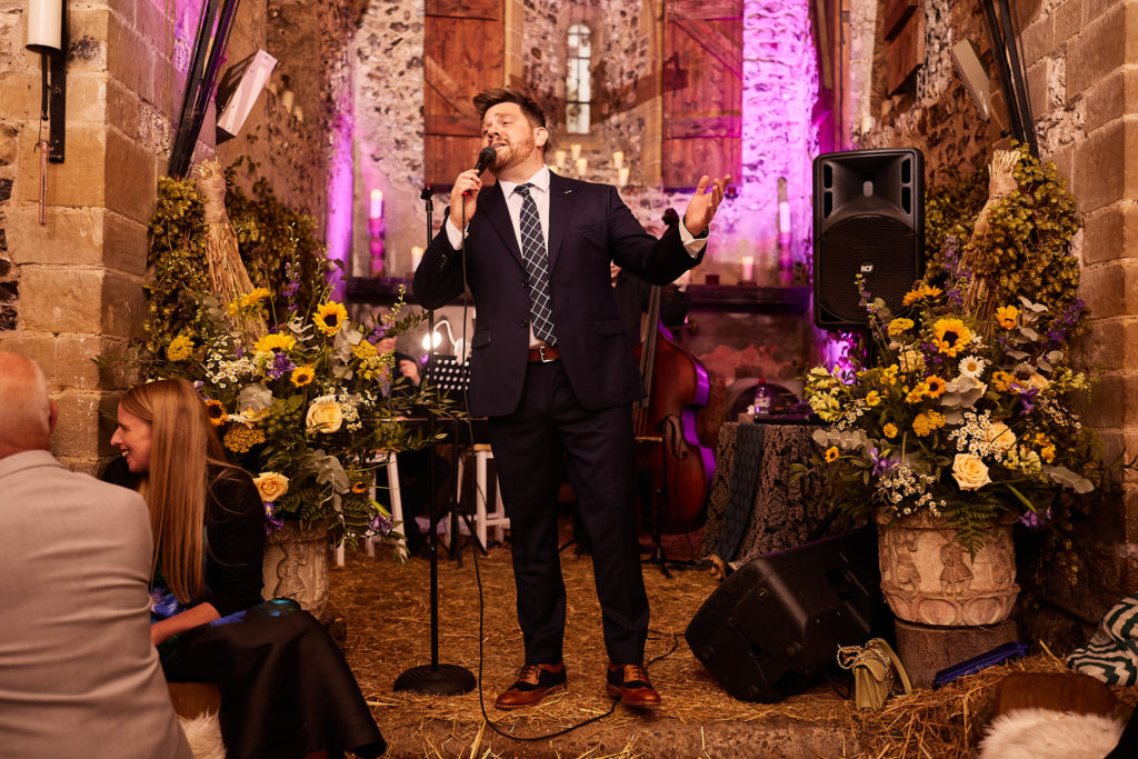 Singer performing inside the church under purple lights