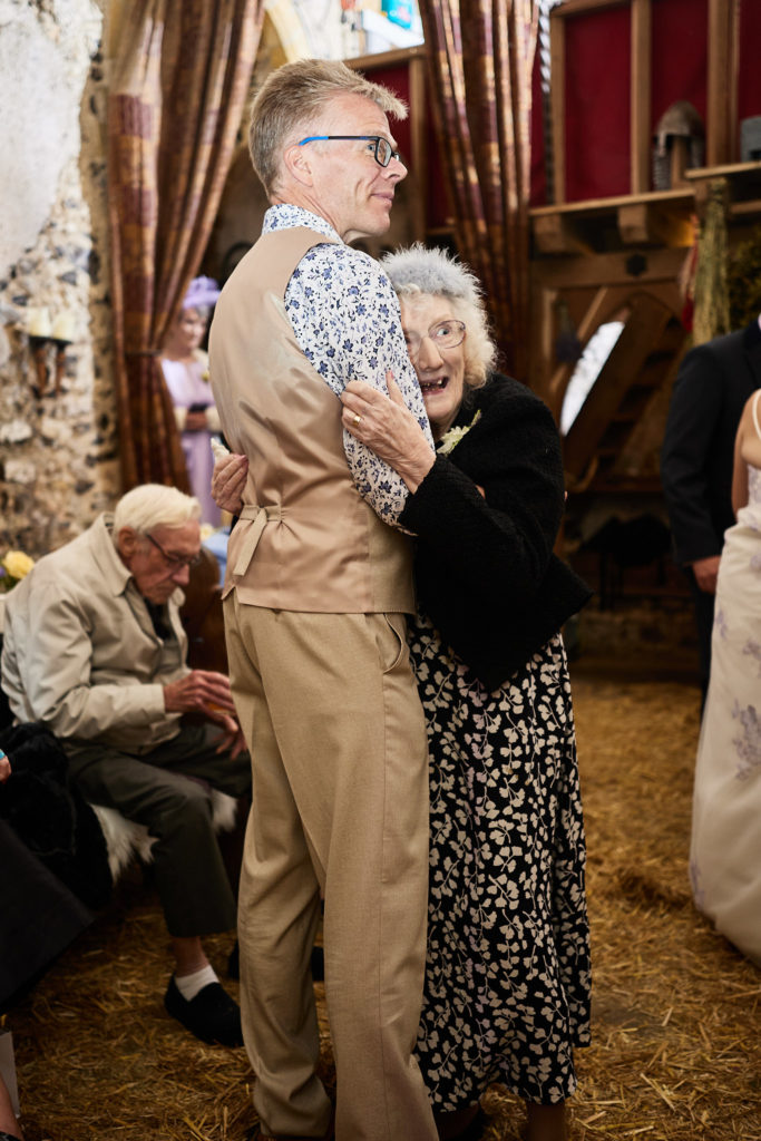 Groom dancing with an elderly woman