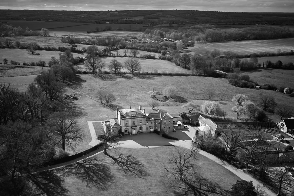 Black and white aerial drone photo of Hatfield Place and the surrounding Essex countryside