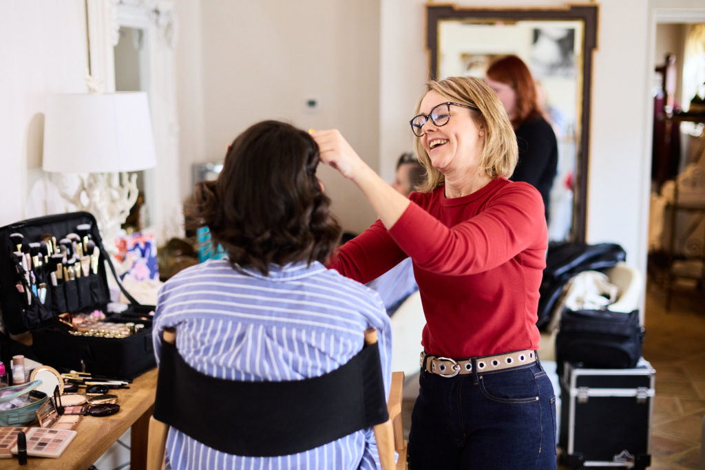 Hair stylist at work during bridal prep at Hatfield Place