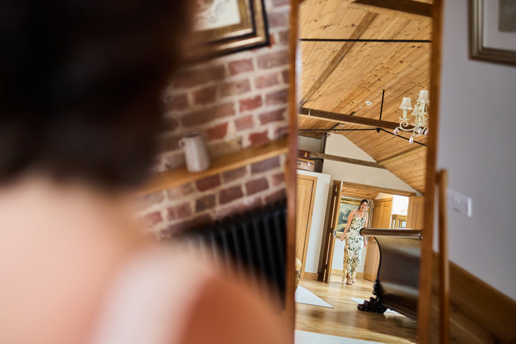 Bride in the foreground looking across the bridal suite