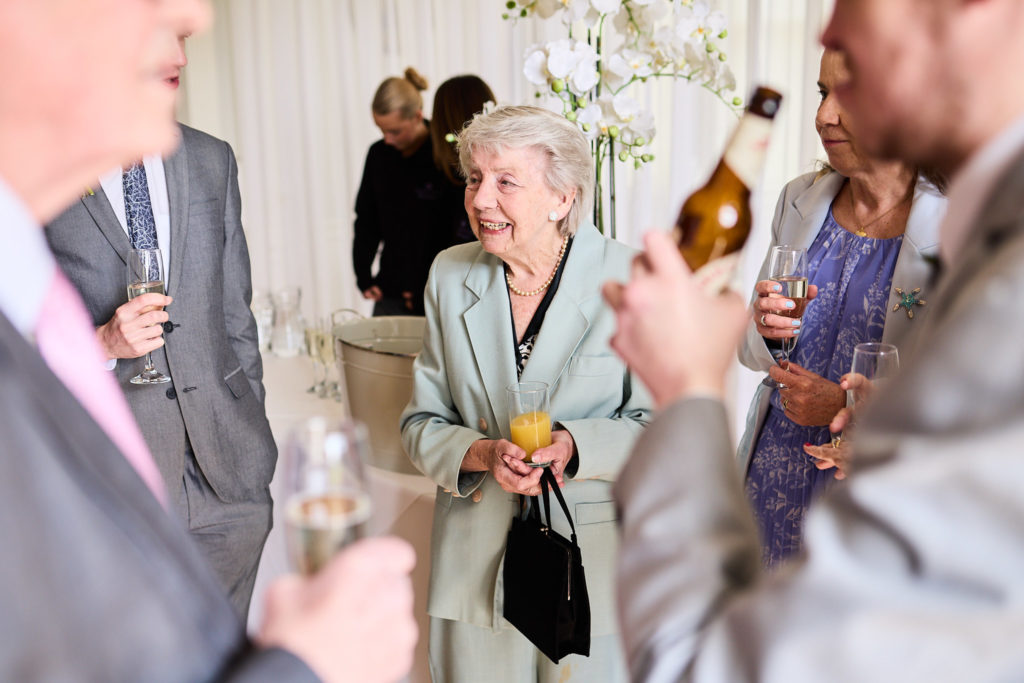 Wedding guests sharing a drink at the reception