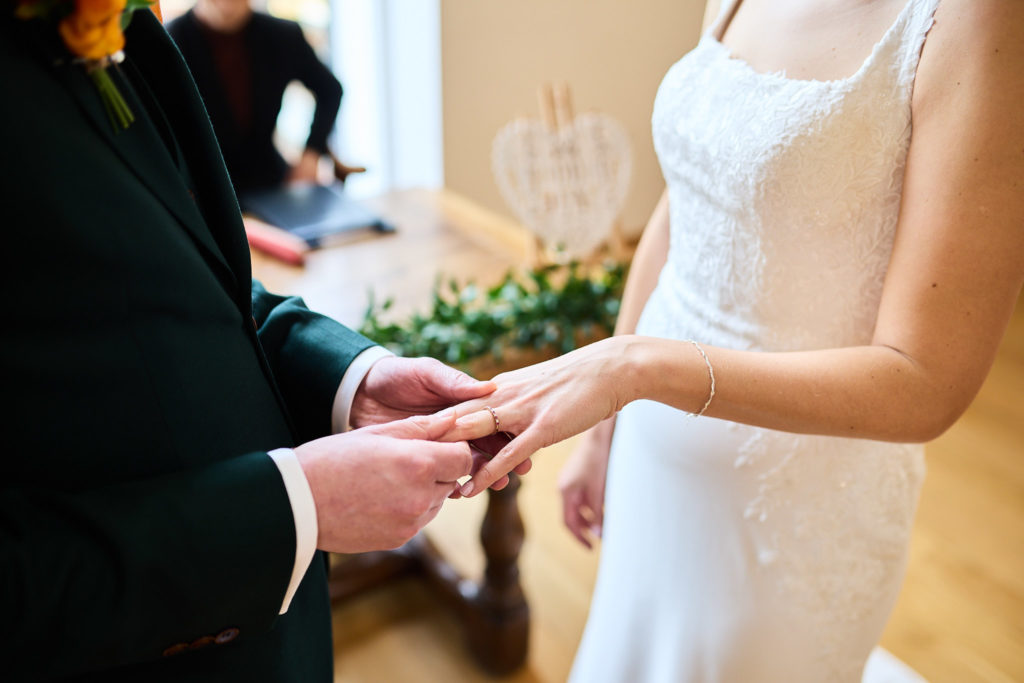 Close-up of the bride and groom exchanging wedding rings