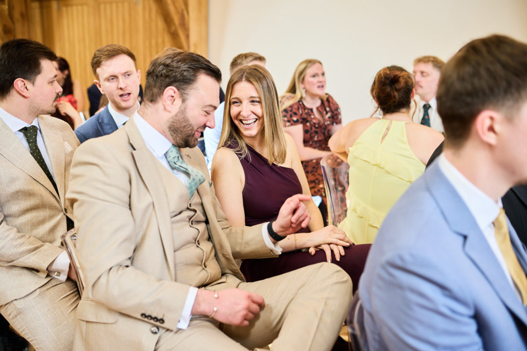 Wedding guests laughing during the ceremony