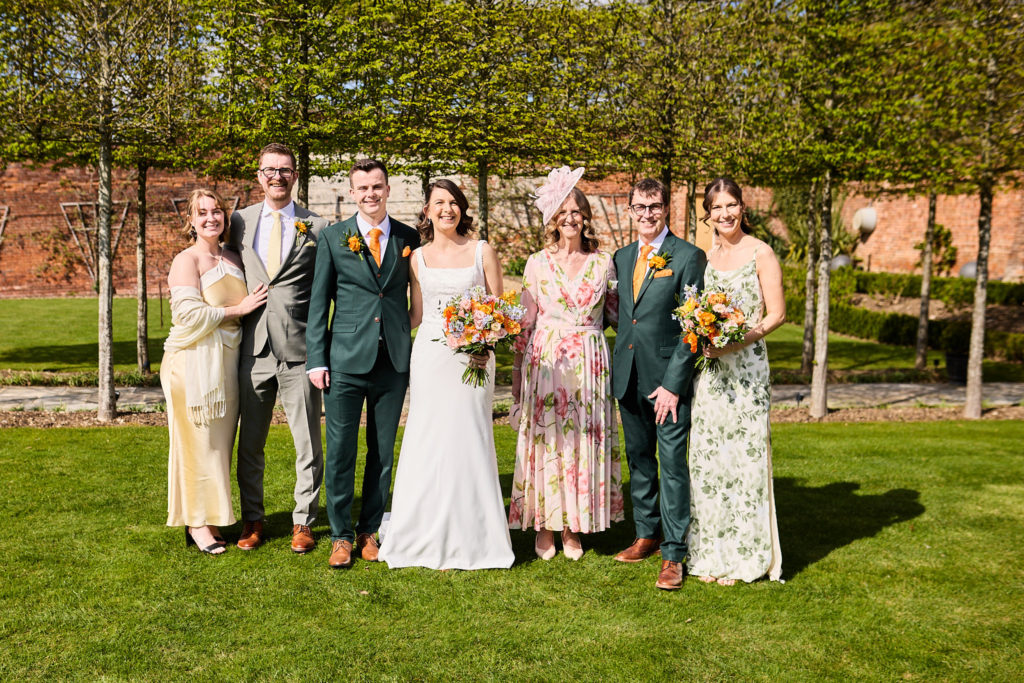 Bride and groom with their wedding party in the walled garden