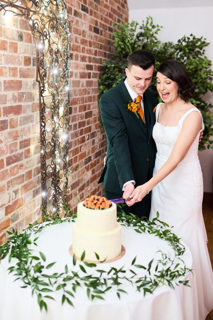 Bride and groom cutting their wedding cake