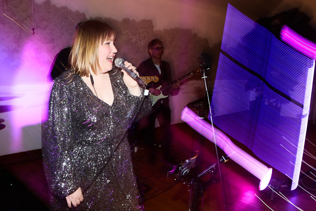 Singer in a sequin dress performing at the evening reception