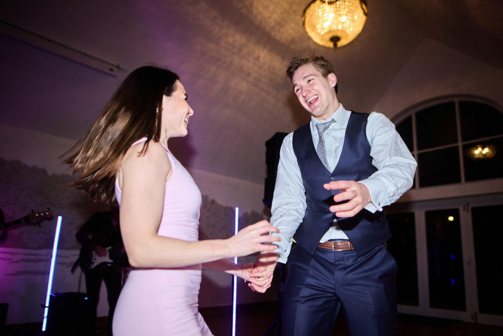 Wedding guests dancing, one with her hair flying