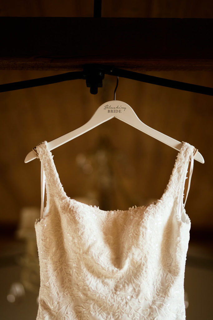 Lace wedding dress bodice on a wooden hanger