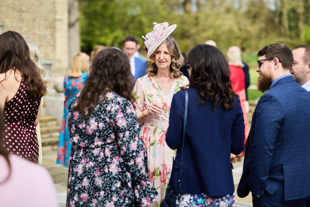 Wedding guests chatting outside before the ceremony