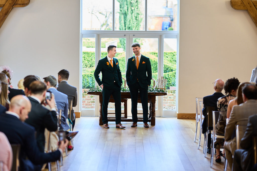 Groom and best man waiting at the front of the ceremony room