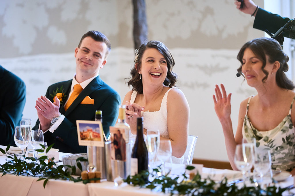 Bride and groom laughing at the top table