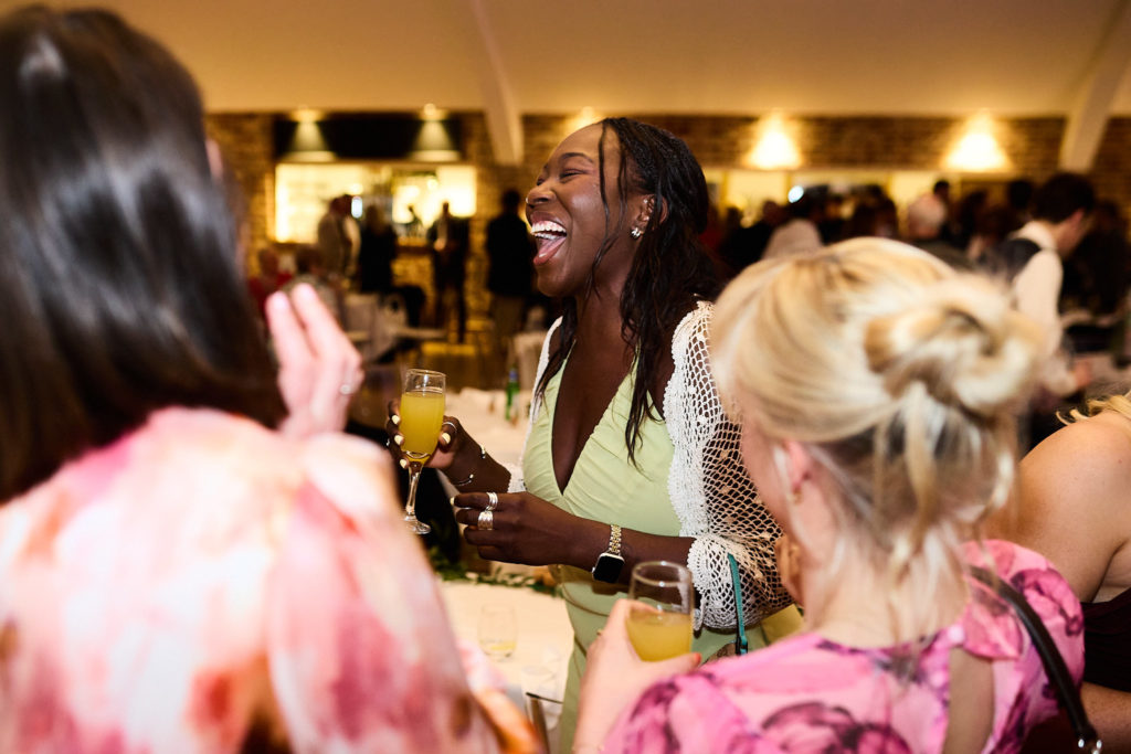 Wedding guests laughing as they dance
