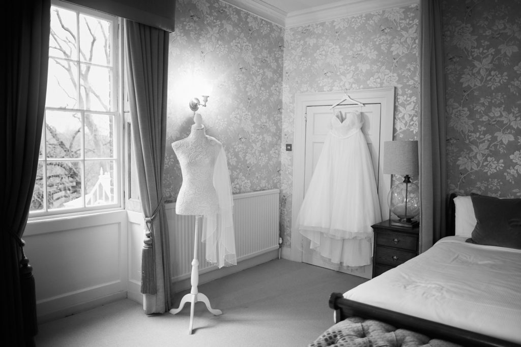 Black and white photo of the wedding dress on a mannequin in the bridal suite
