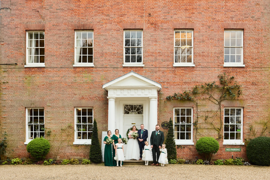 Wedding party in front of the red-brick Georgian front of Mulberry House