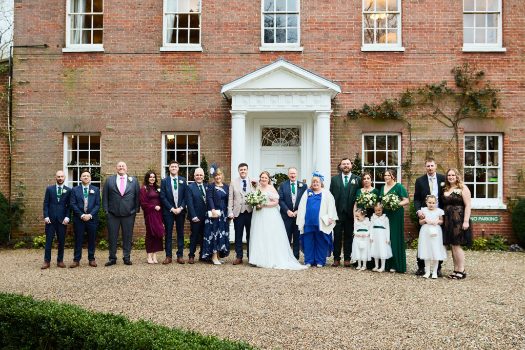 Group photo of all the wedding guests in front of Mulberry House