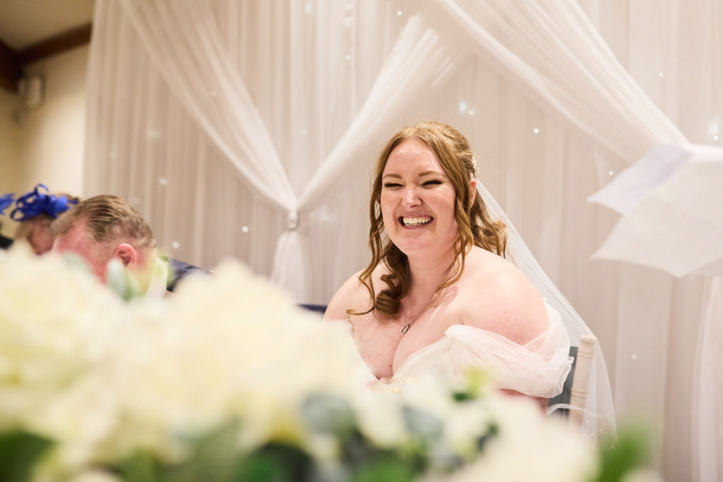 Bride laughing at the top table