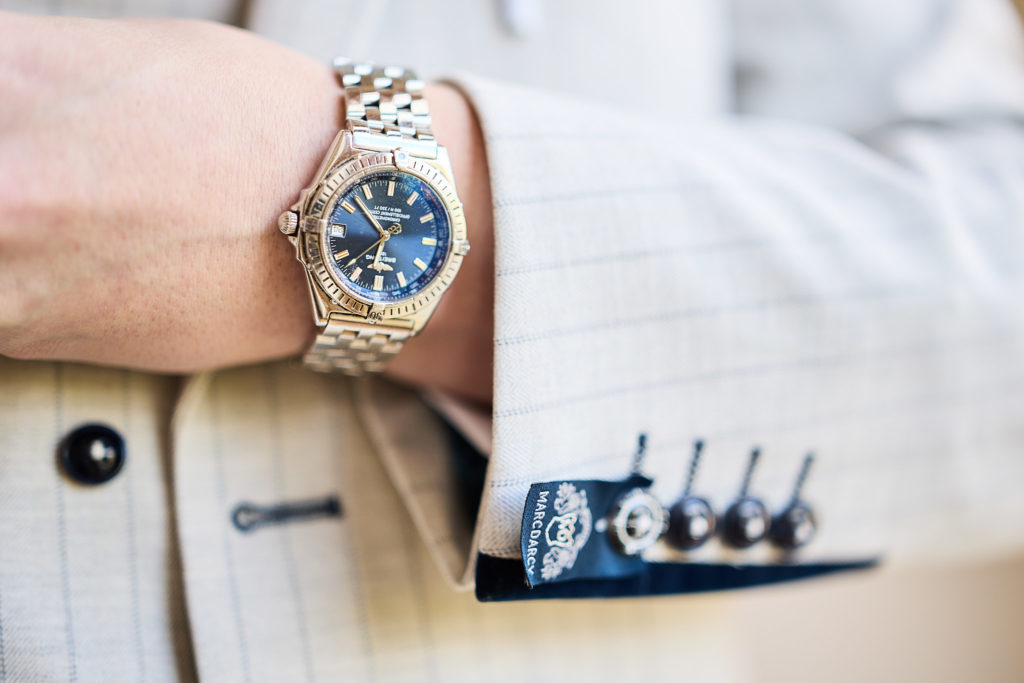 Close-up of the groom's watch and suit cuff