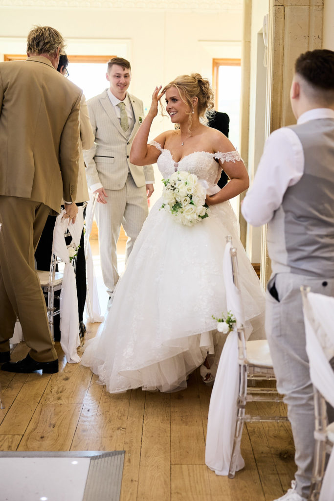 Bride arriving in the ceremony room with her bouquet