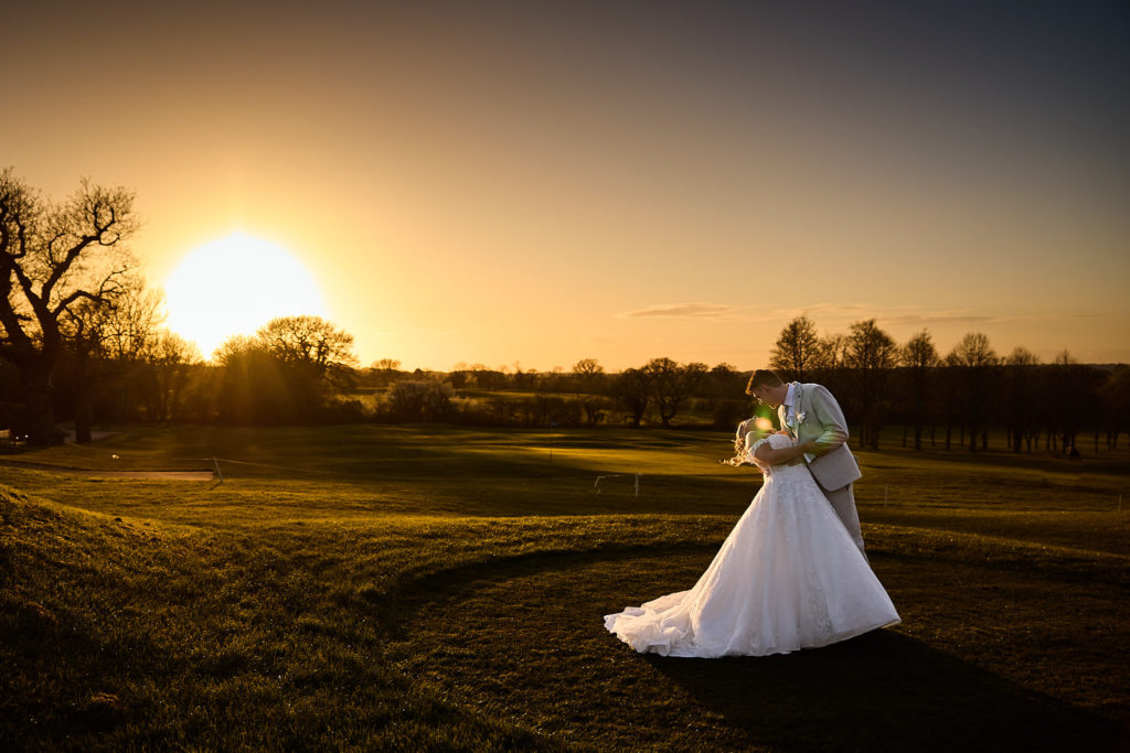 Bride standing in a field at sunset at Stock Brook Manor
