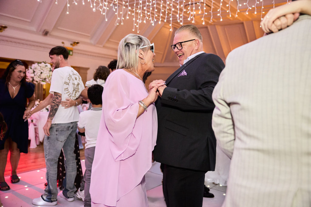 Wedding guests greeting each other on the dance floor