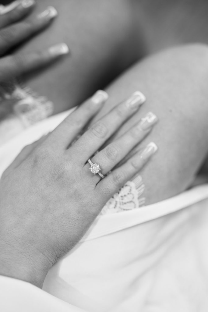 Black and white close-up of the bride's hand and engagement ring