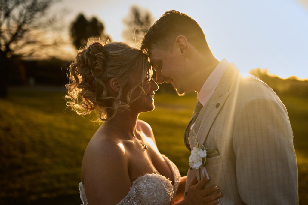Bride and groom forehead to forehead at sunset at Stock Brook Manor