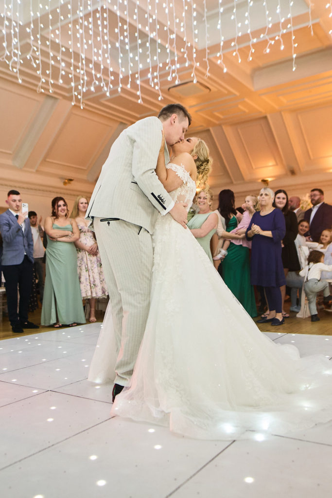 Groom dipping the bride for a kiss during their first dance