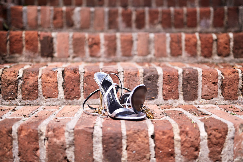 Bridal shoes on a red-brick wall
