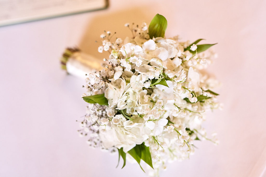 Bouquet of white flowers and foliage, seen from above