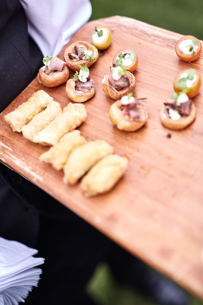 Tray of canapés on a wooden board