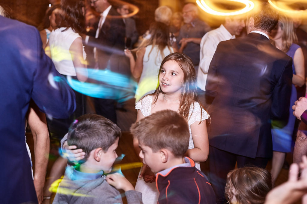 Children dancing with glow sticks on the dance floor