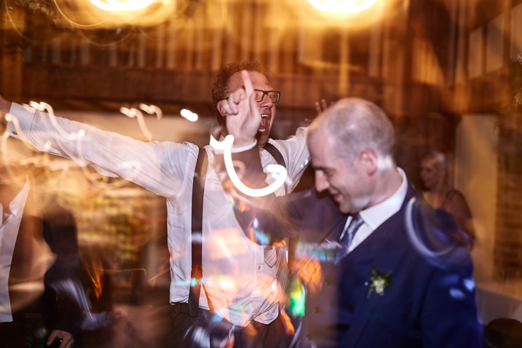 Bride and groom dancing among streaks of light at The Swan at Lavenham
