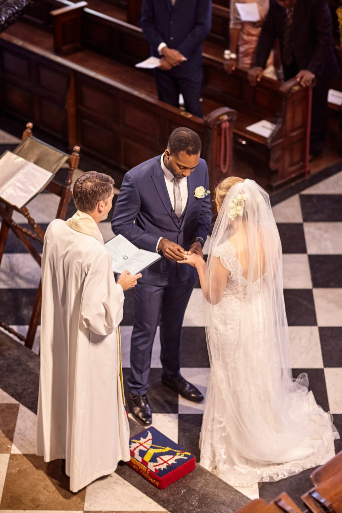 Bride and groom exchanging rings before the priest, seen from above