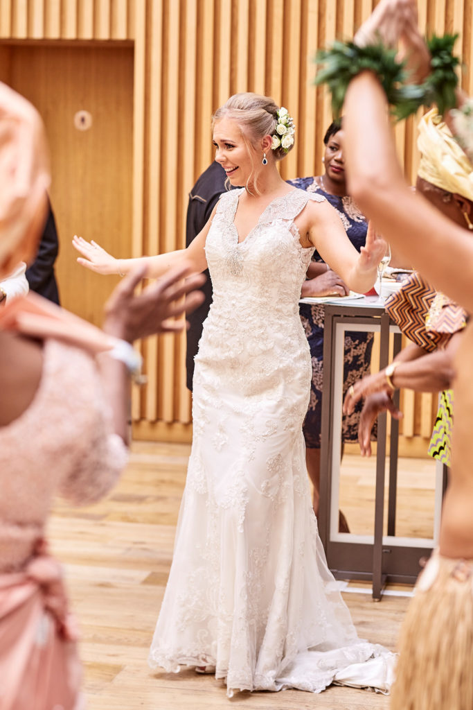 Bride dancing with Polynesian dancers in grass skirts