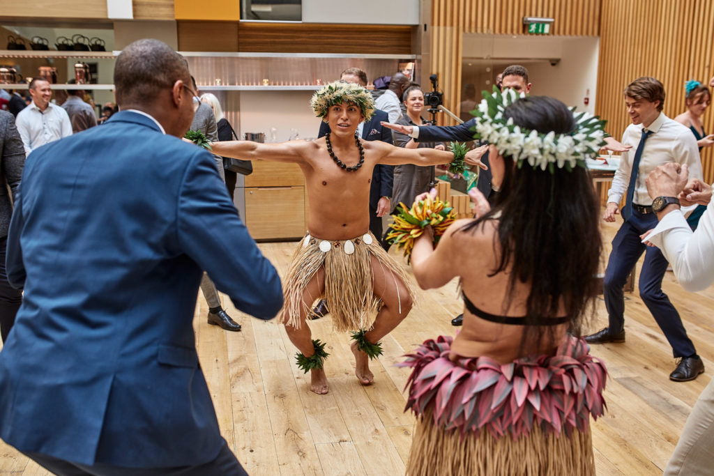 Groom joining in with the Polynesian dancers as guests watch