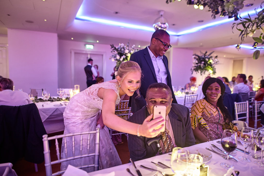 Bride greeting guests at their table