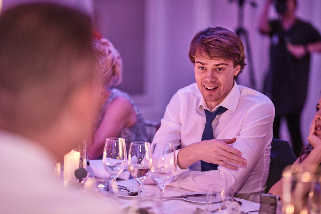 Wedding guest laughing at the table