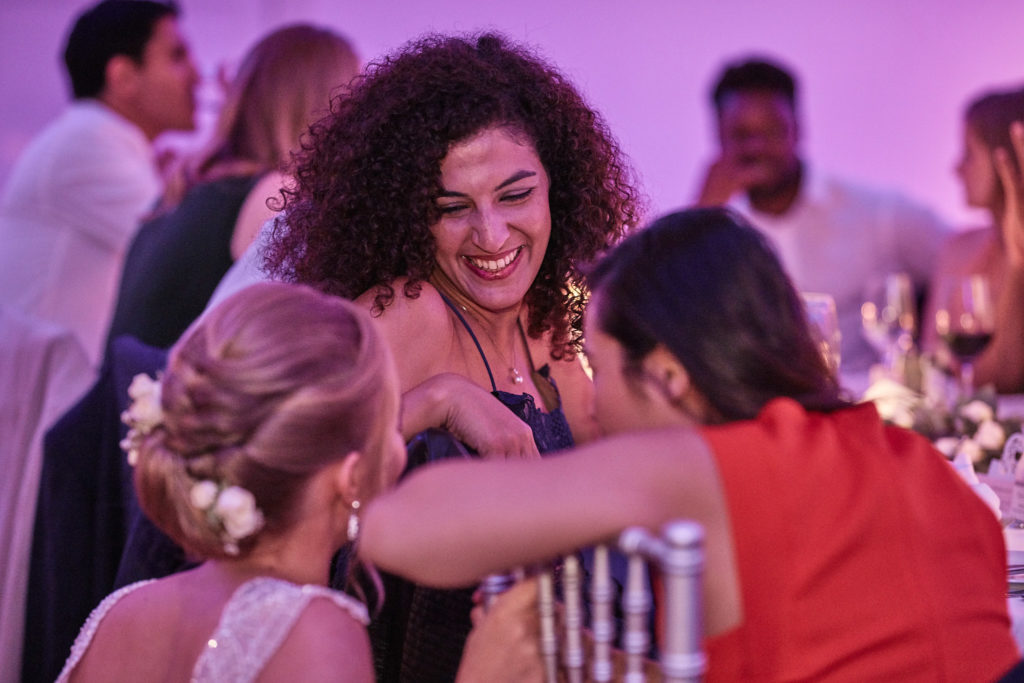 Wedding guests hugging at the table