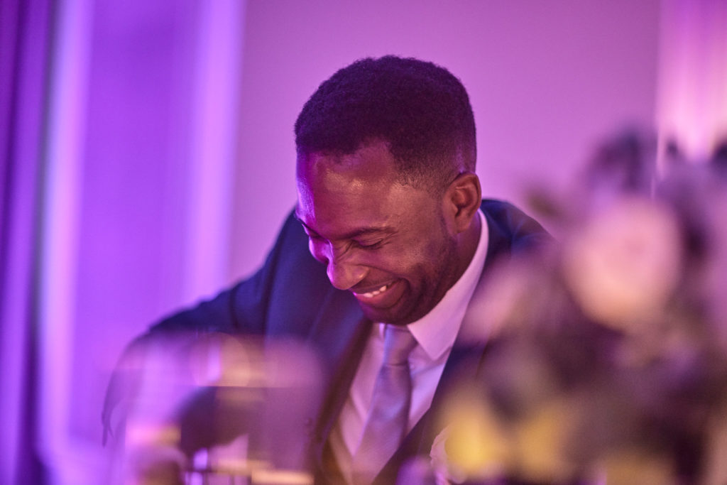 Groom laughing during the speeches