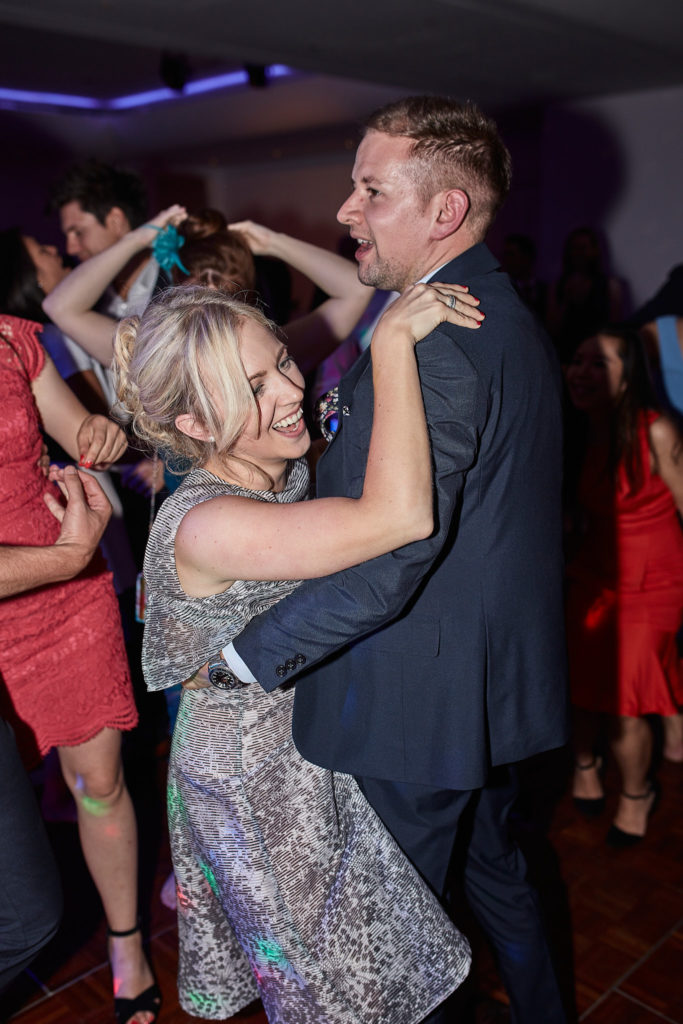 Two wedding guests dancing together
