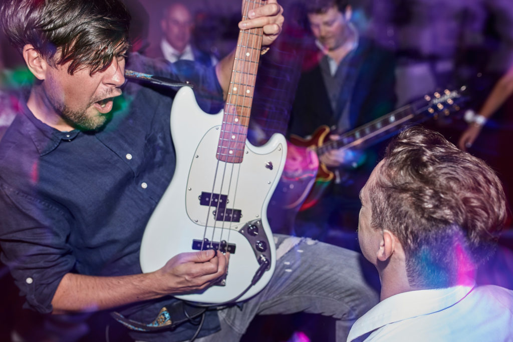 Bass guitarist performing in the middle of the dance floor
