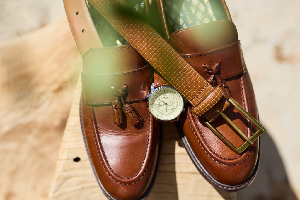 Tan leather loafers with a watch and green suede belt